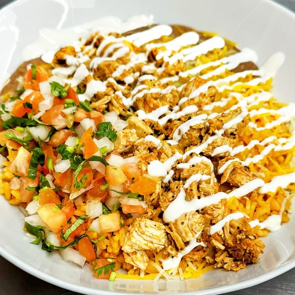 Marabella's Tacos' Mexican bowl with chicken, rice, beans, pico de gallo, cheese, and crema.
